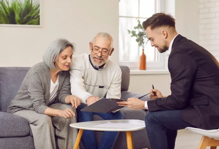 elderly couple discussing insurance claim process with public adjuster