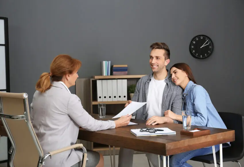 Public Adjuster having meeting with young couple in office