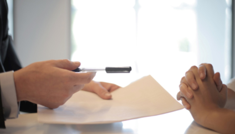 Insurance adjuster reviewing documents with a lady.