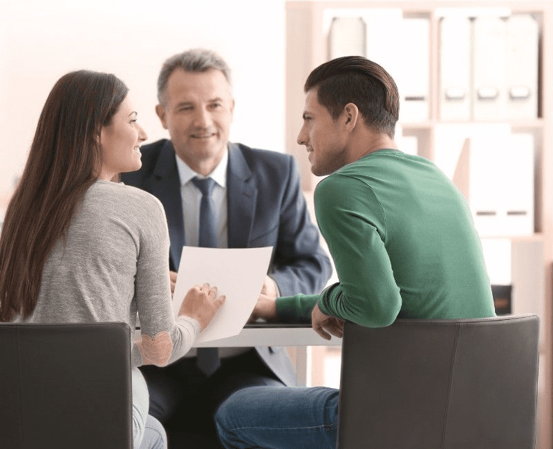 Young couple speaking with a public adjuster