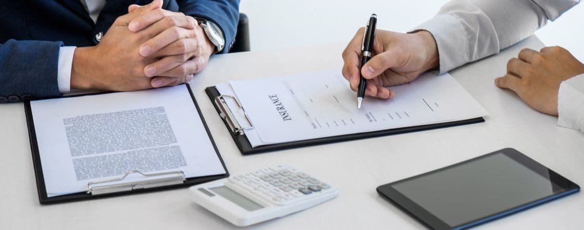 Customer signing insurance documents