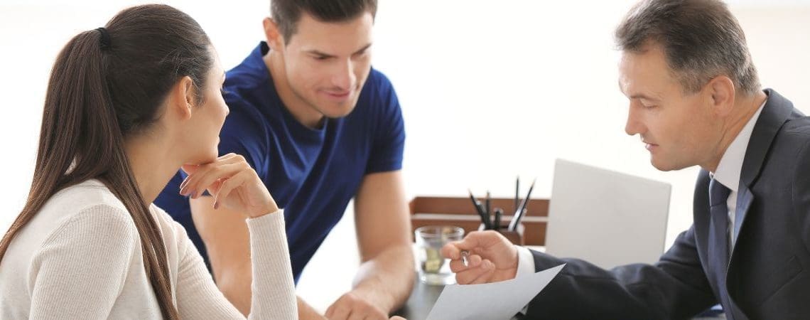 Public adjuster going over paperwork with couple
