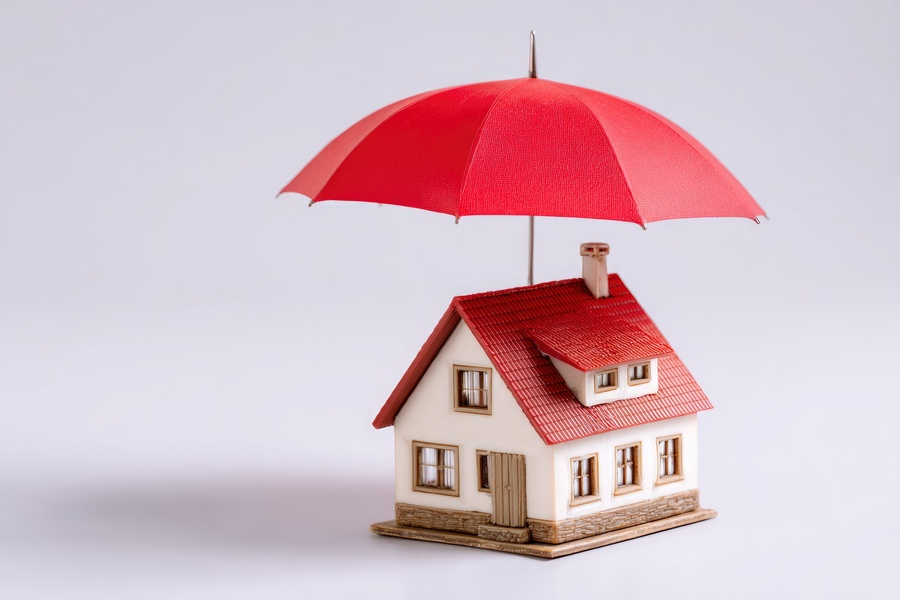 house model with umbrella - insurance concept