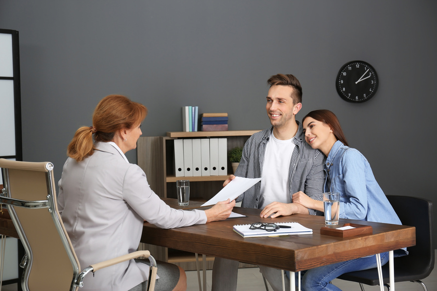 Public Adjuster having meeting with young couple in office
