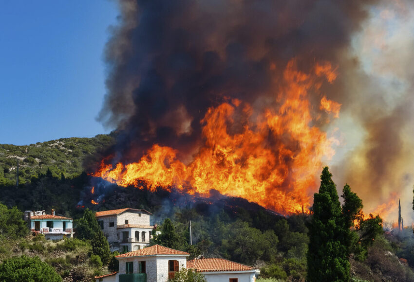forest wildfire reaching homes