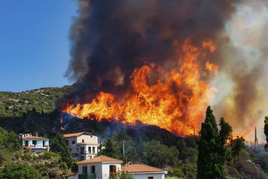 forest wildfire reaching homes