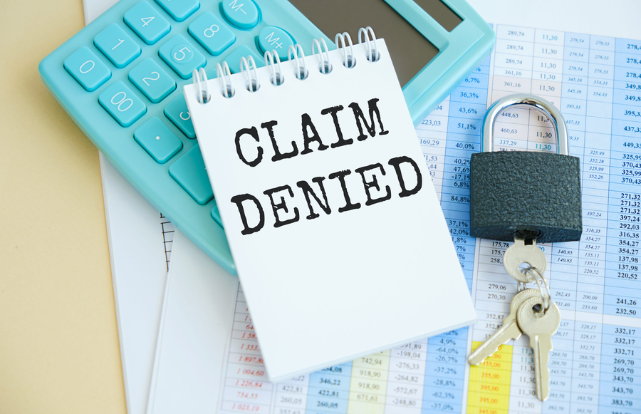 Glasses and calculator with text Claim Denied