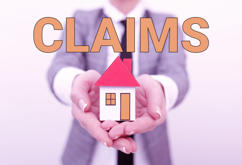 commercial property insurance claims. Public adjuster holding a house model
