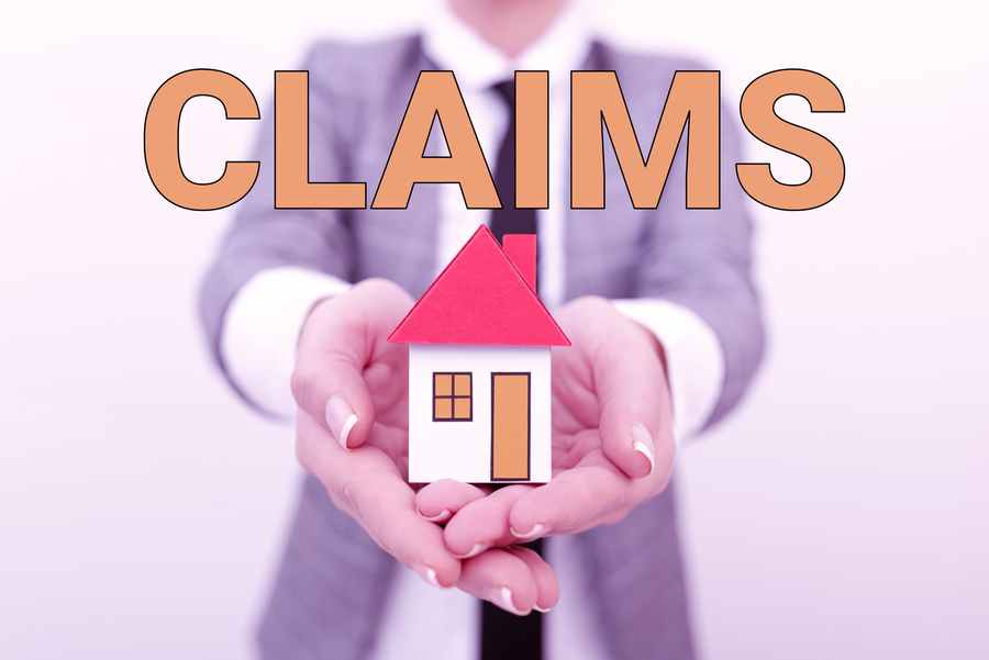 commercial property insurance claims. Public adjuster holding a house model